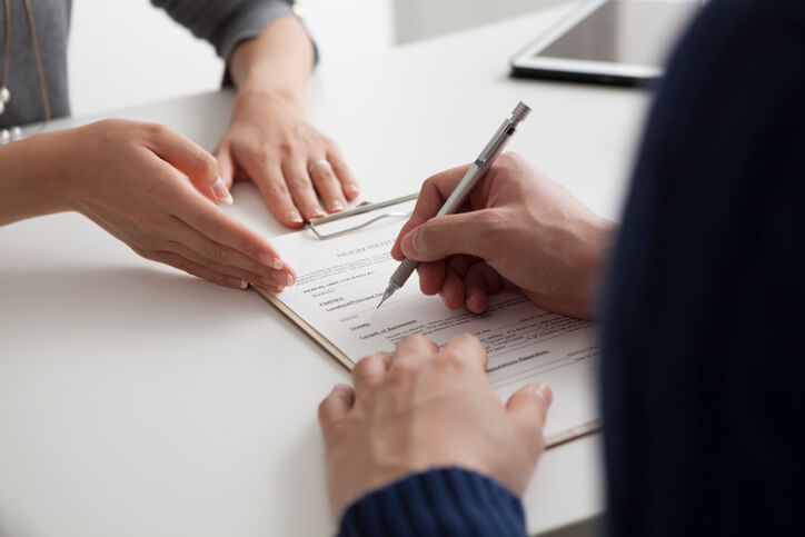Young man looking over estate planning document