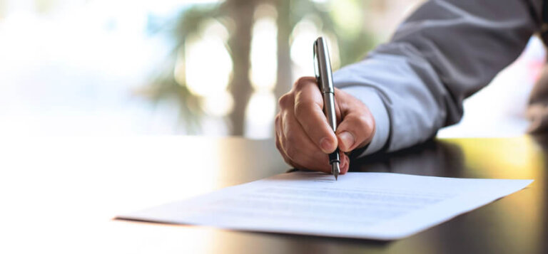 Man signing business planning document