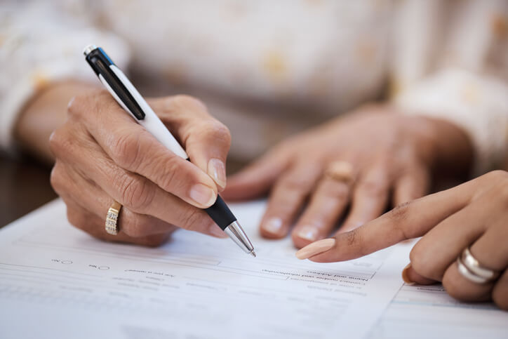 Woman signing estate planning documents