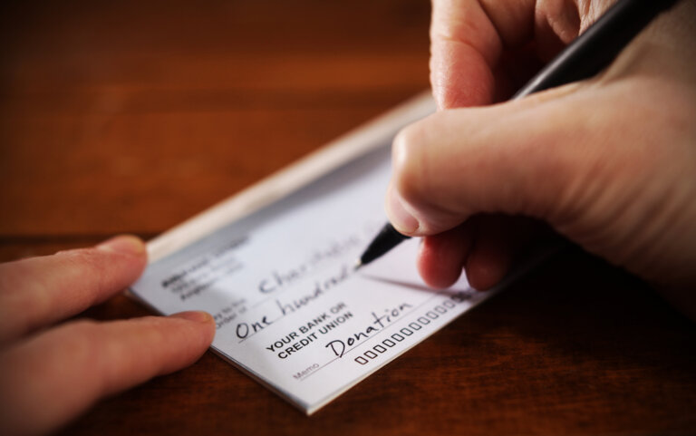 image of a person writing the check for a charity in fort-worth/dallas texas