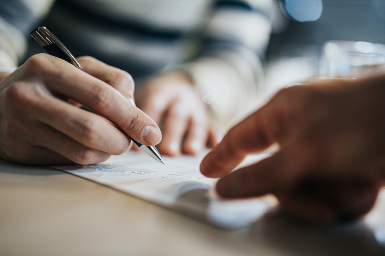 Lawyer directing a client to sign a trust