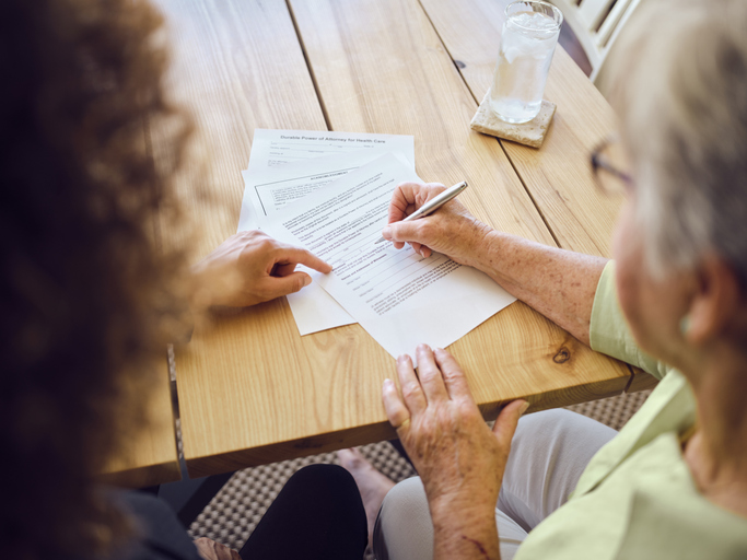 Senior woman signing a trust document