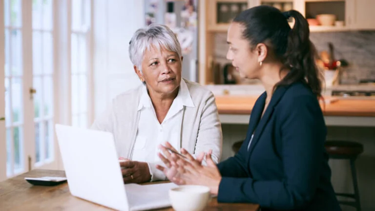 Older woman estate planning with her attorney