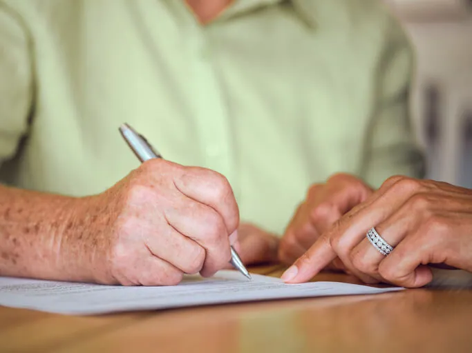 Older woman estate planning with attorney