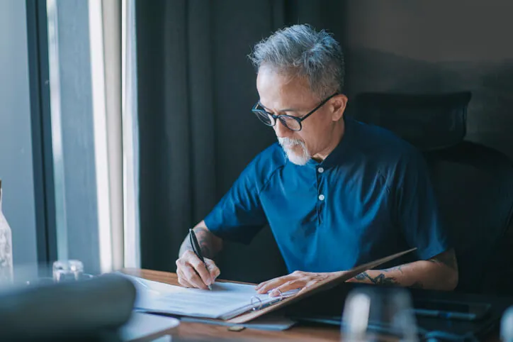 A man signing documents