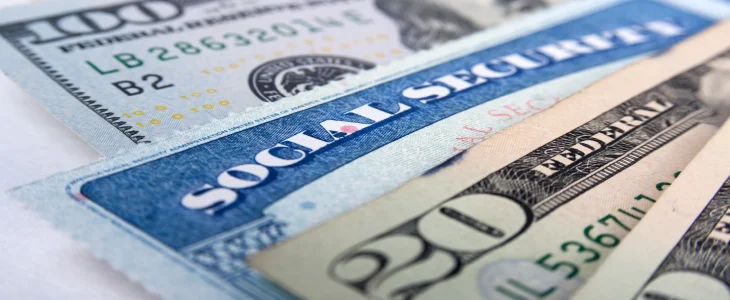money and a social security card next to each other representing social security income