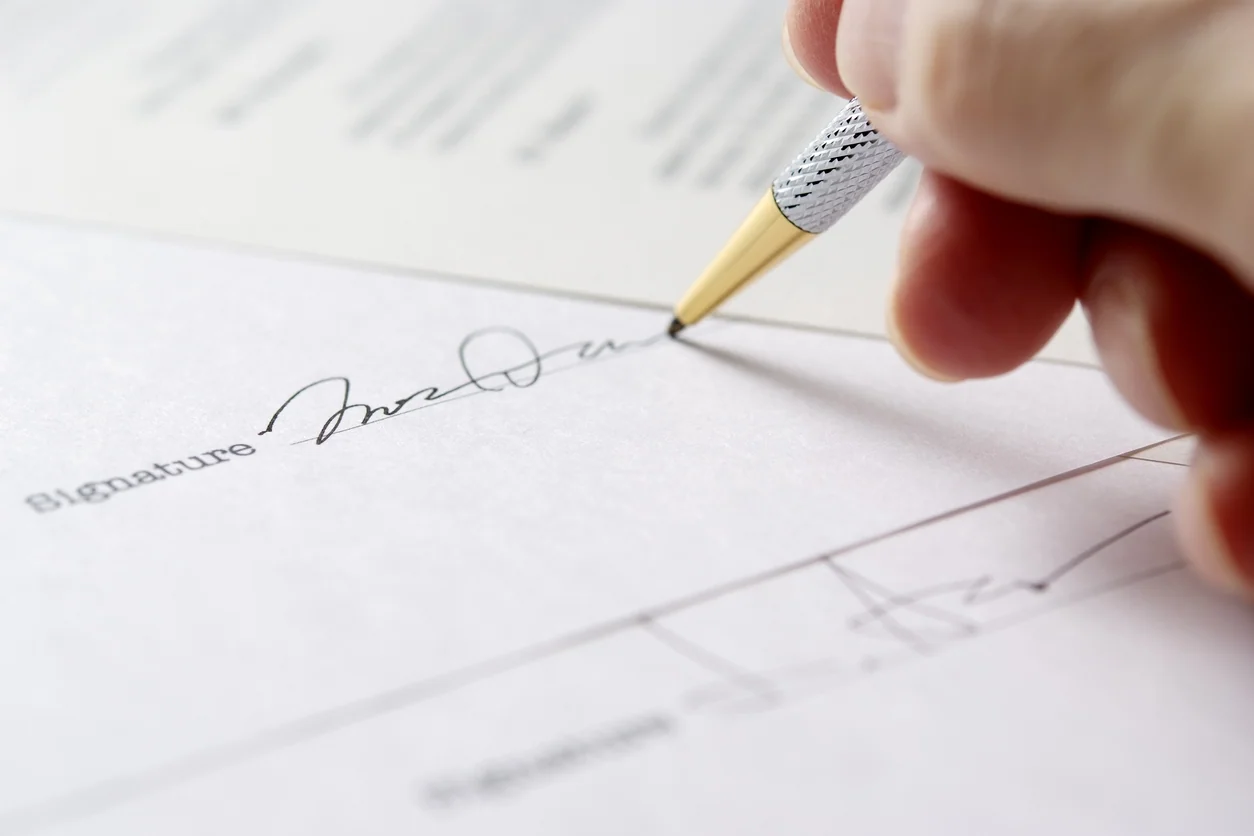 Close-up of signing a contract will.
